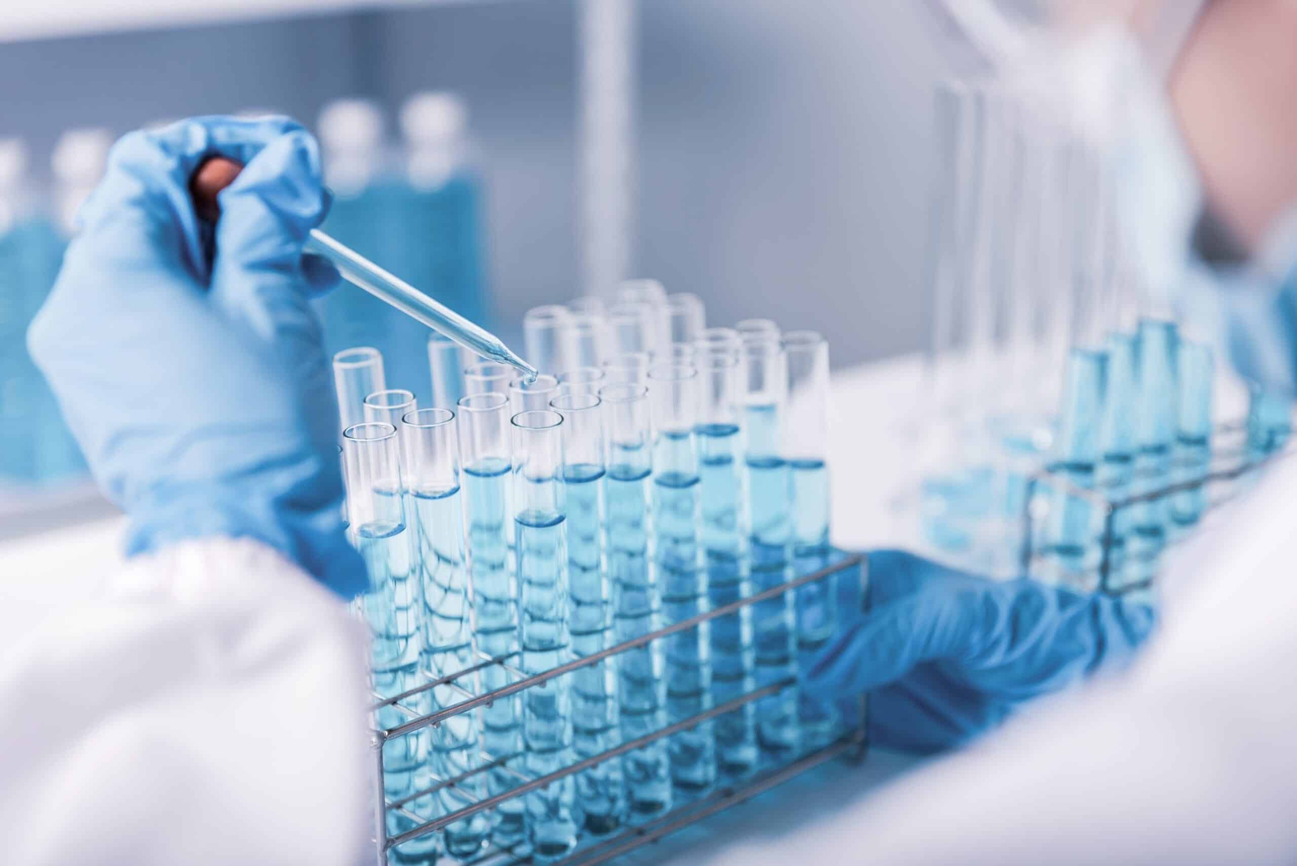 Chemist,scientist,hand,dropping,chemical,liquid,into,test,tube,,science,research
